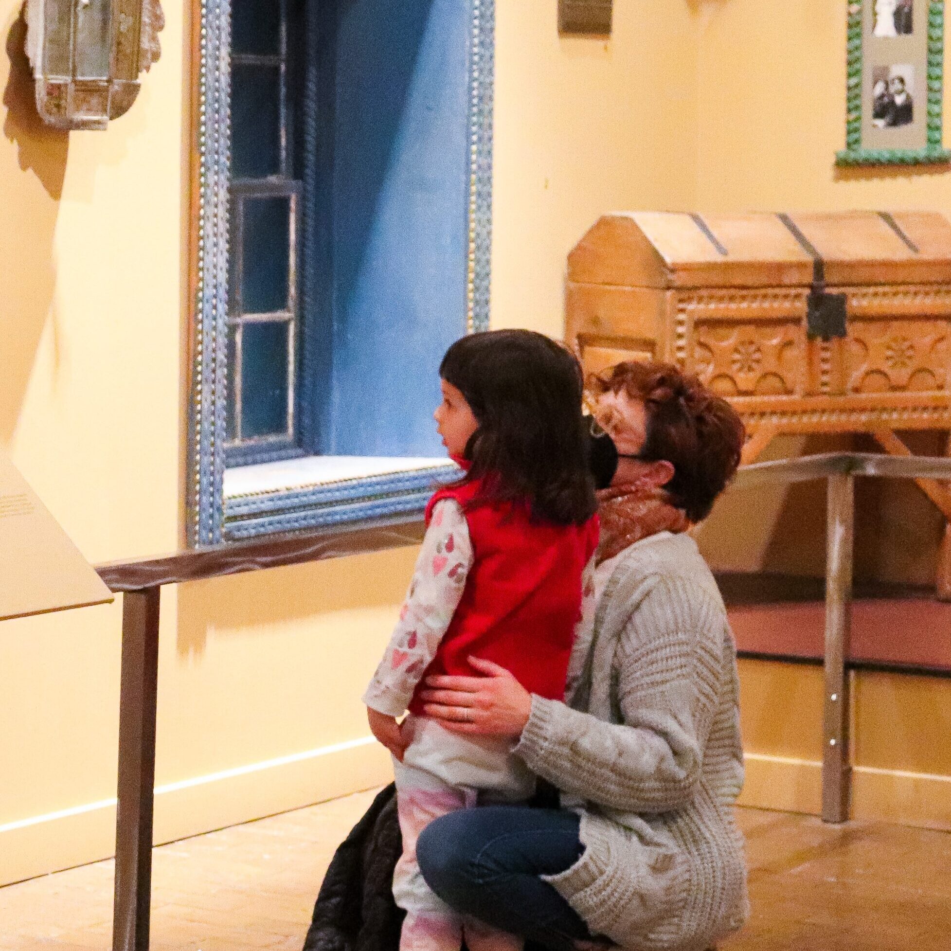 Grandparent and child talk in the "Common Ground: Art in New Mexico" gallery in Albuquerque Museum. PHOTO: Nora Vanesky 2022